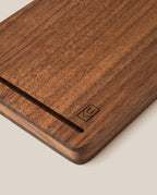 A close-up of the Analog Travel Case + 3 Card Packs (Walnut), showcasing its rectangular walnut construction with a smooth groove and a subtle engraved logo in the corner, set against a light background.