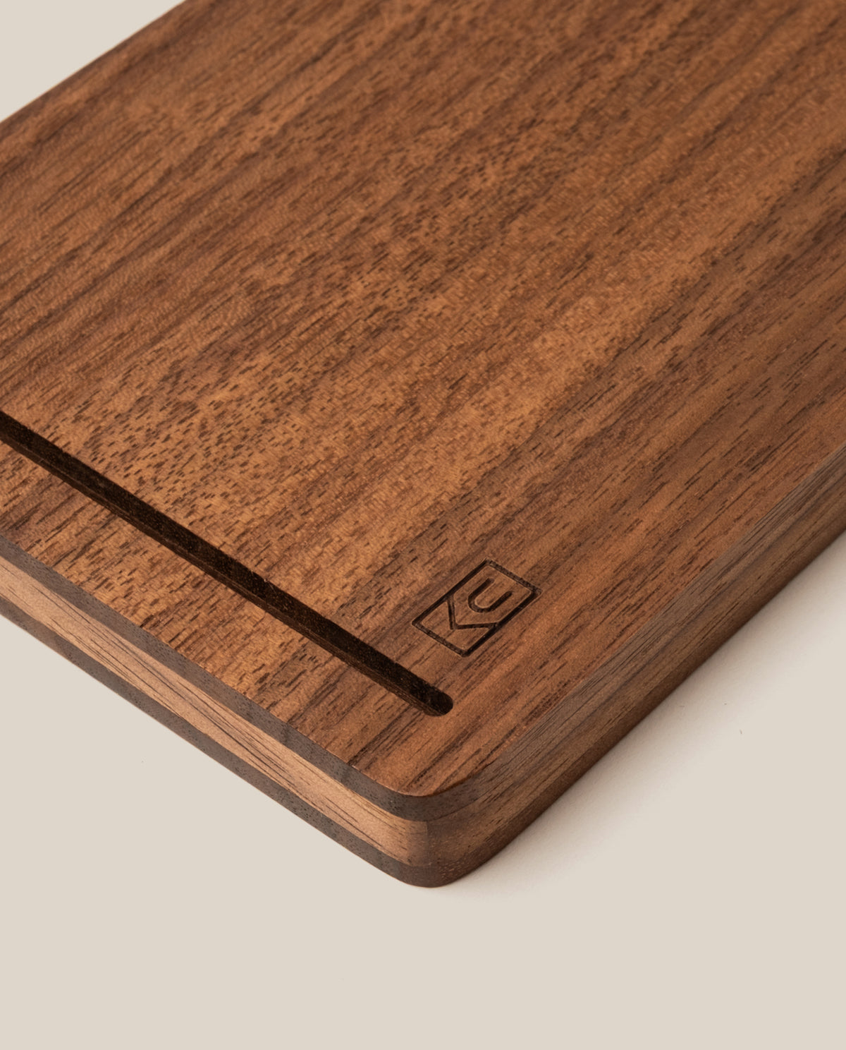 A close-up of the Analog Travel Case + 3 Card Packs (Walnut), showcasing its rectangular walnut construction with a smooth groove and a subtle engraved logo in the corner, set against a light background.