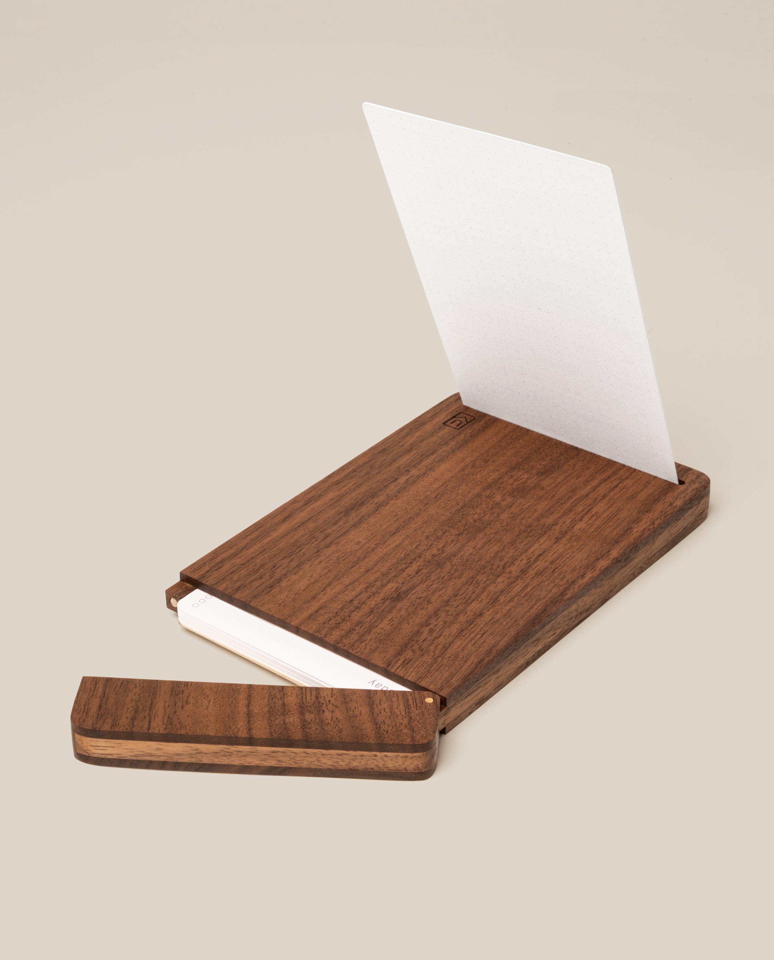 The Analog Bundle (Walnut) features a wooden kit with a sliding lid, shown partially open to display white index cards inside. A single card stands upright in the walnut holder against a plain light beige background.
