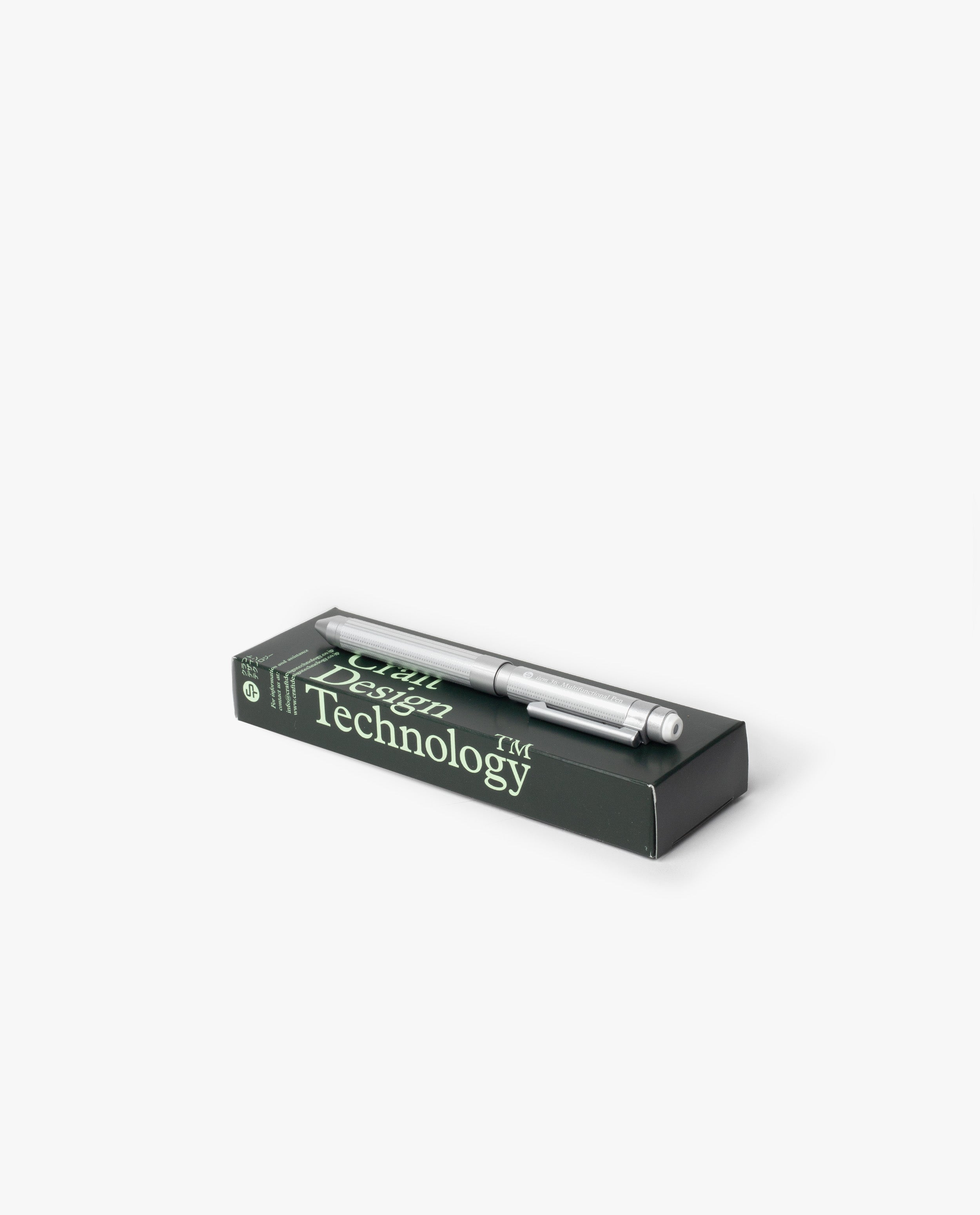 A silver Craft Design Technology Multifunctional Pen rests atop a dark green box labeled with the brand, set against a plain white background.