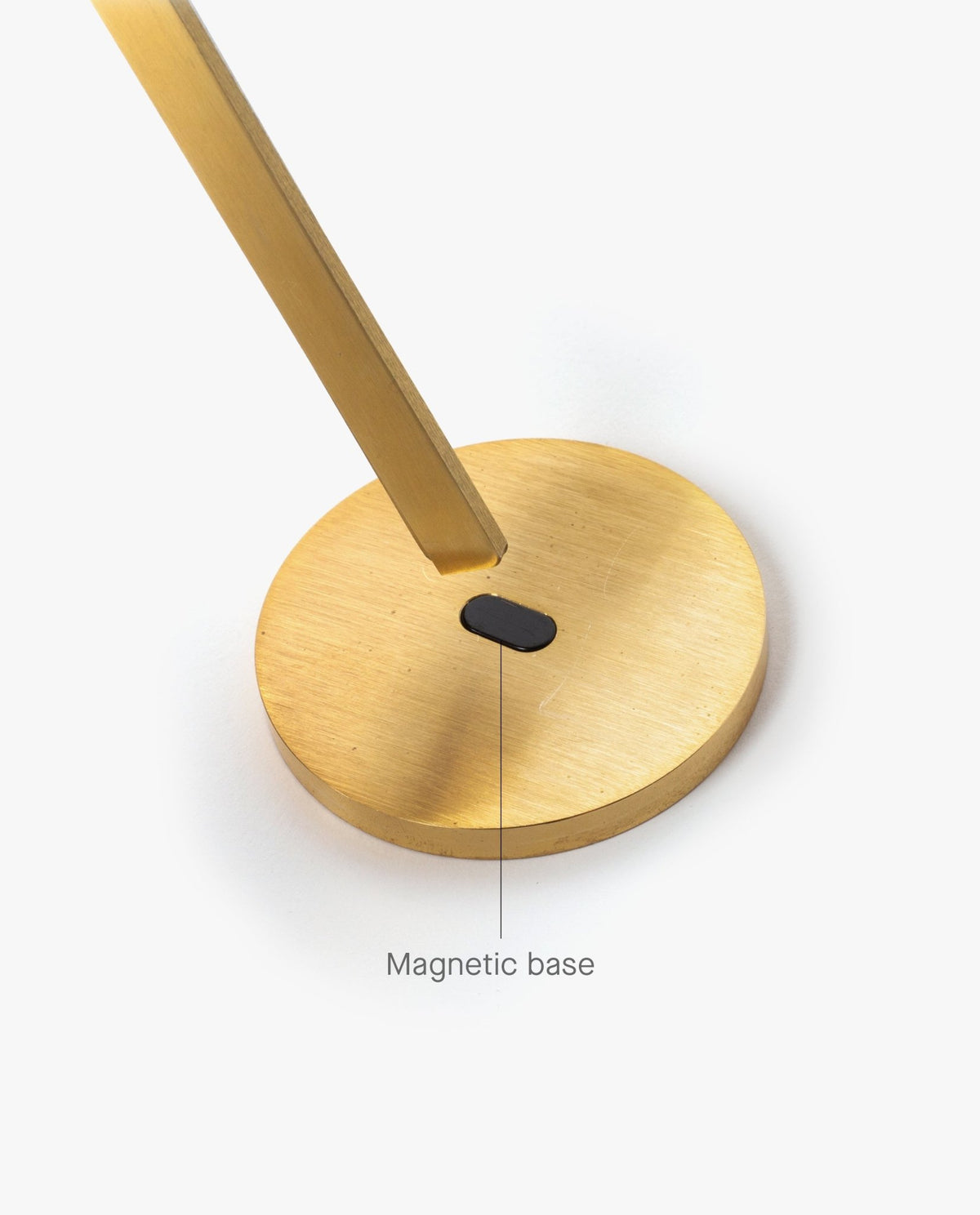 A gold-colored circular base with a rectangular stand attached and a small black section labeled Magnetic base on a white background, perfect for securely holding your HMM Scissors (Gold) or other magnetic scissors.