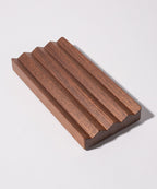 The Gather Wood Zigzag Tray (2x1 - Walnut) is crafted from solid walnut and features a unique zigzag design, making it a stylish holder for pens and pencils.