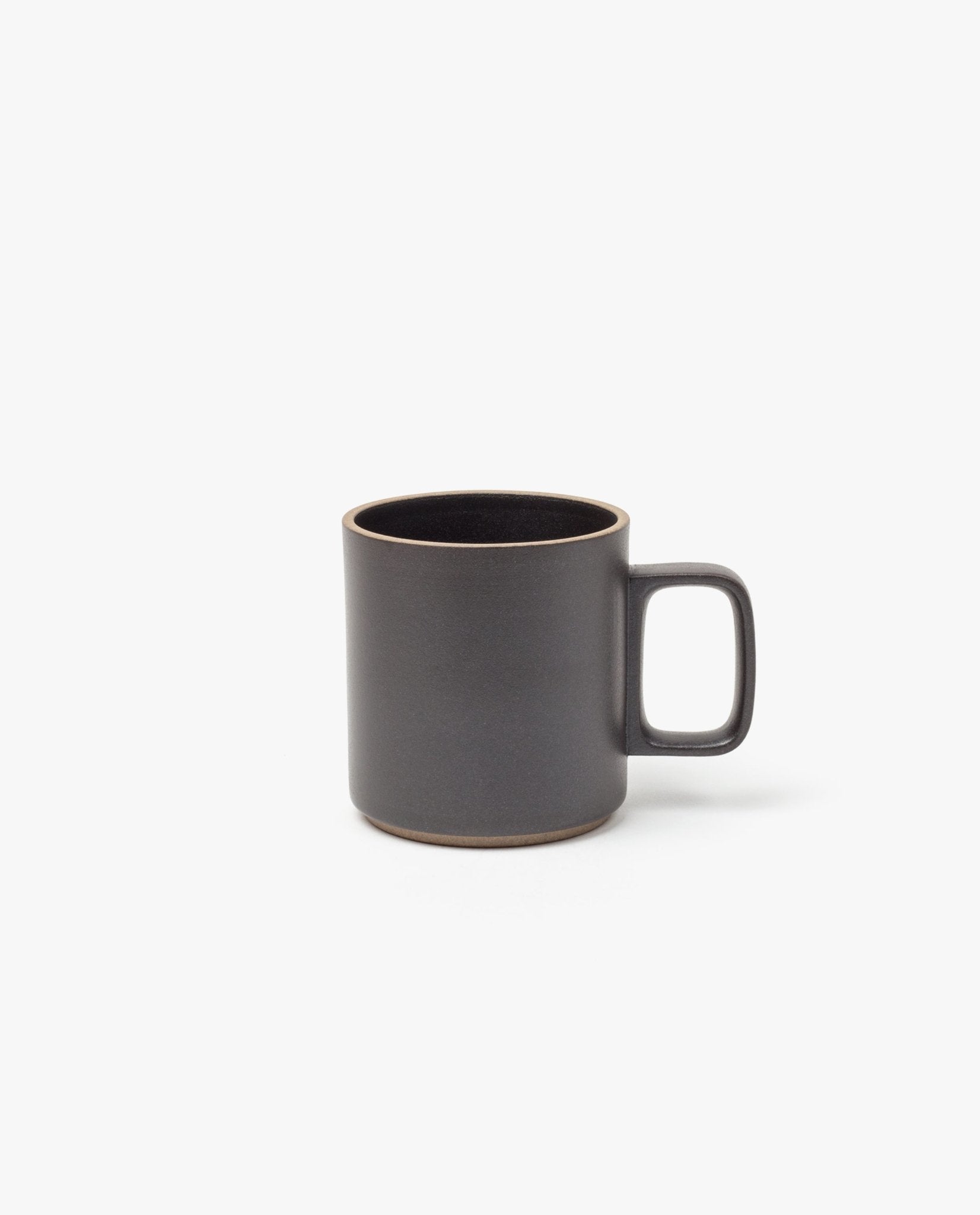 The Hasami Porcelain Mug (Matte Black) features a plain, modern design with a large handle and slightly rounded rim, shown here on a white background.