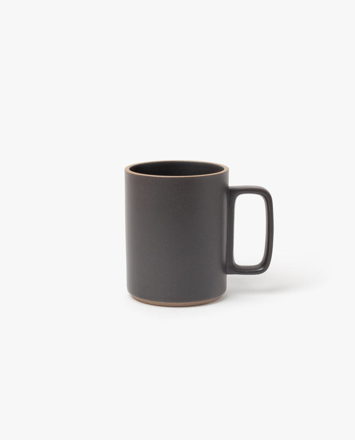 The Hasami Porcelain Mug (Matte Black) features a large rectangular handle and natural brown ceramic edges on the rim and base, highlighting its handmade look inspired by classic Japanese design. Photographed against a plain white background.