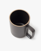 The Hasami Porcelain Mug (Matte Black) features a square handle and is shown from above and slightly to the side on a plain white background, highlighting its visible rim and interior.