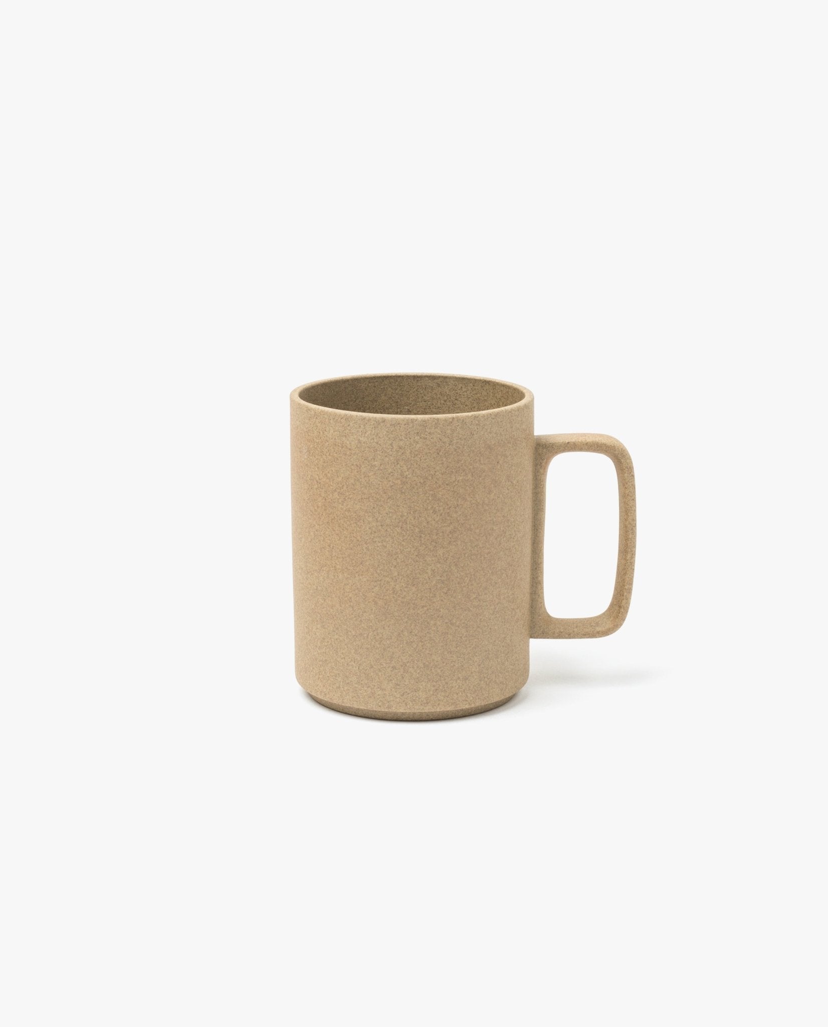 A Hasami Porcelain Mug (Natural) with a square handle in light brown sits on a white background, evoking the simplicity of traditional Japanese ceramics.