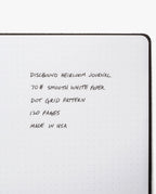 An open Discbound Heirloom Journal Bundle in brown full-grain leather (6" x 8.5") with smooth 70# white dot grid paper, 120 pages, refillable and handmade in the USA. Includes three refills.