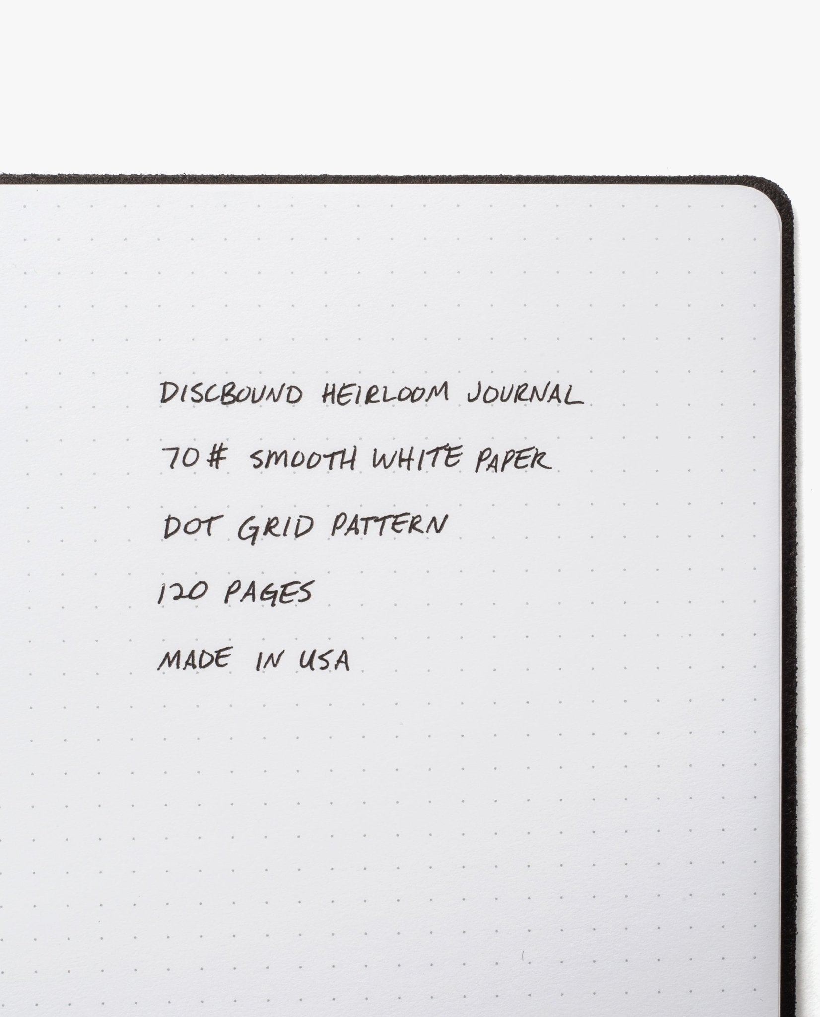 An open Discbound Heirloom Journal Bundle in brown full-grain leather (6" x 8.5") with smooth 70# white dot grid paper, 120 pages, refillable and handmade in the USA. Includes three refills.