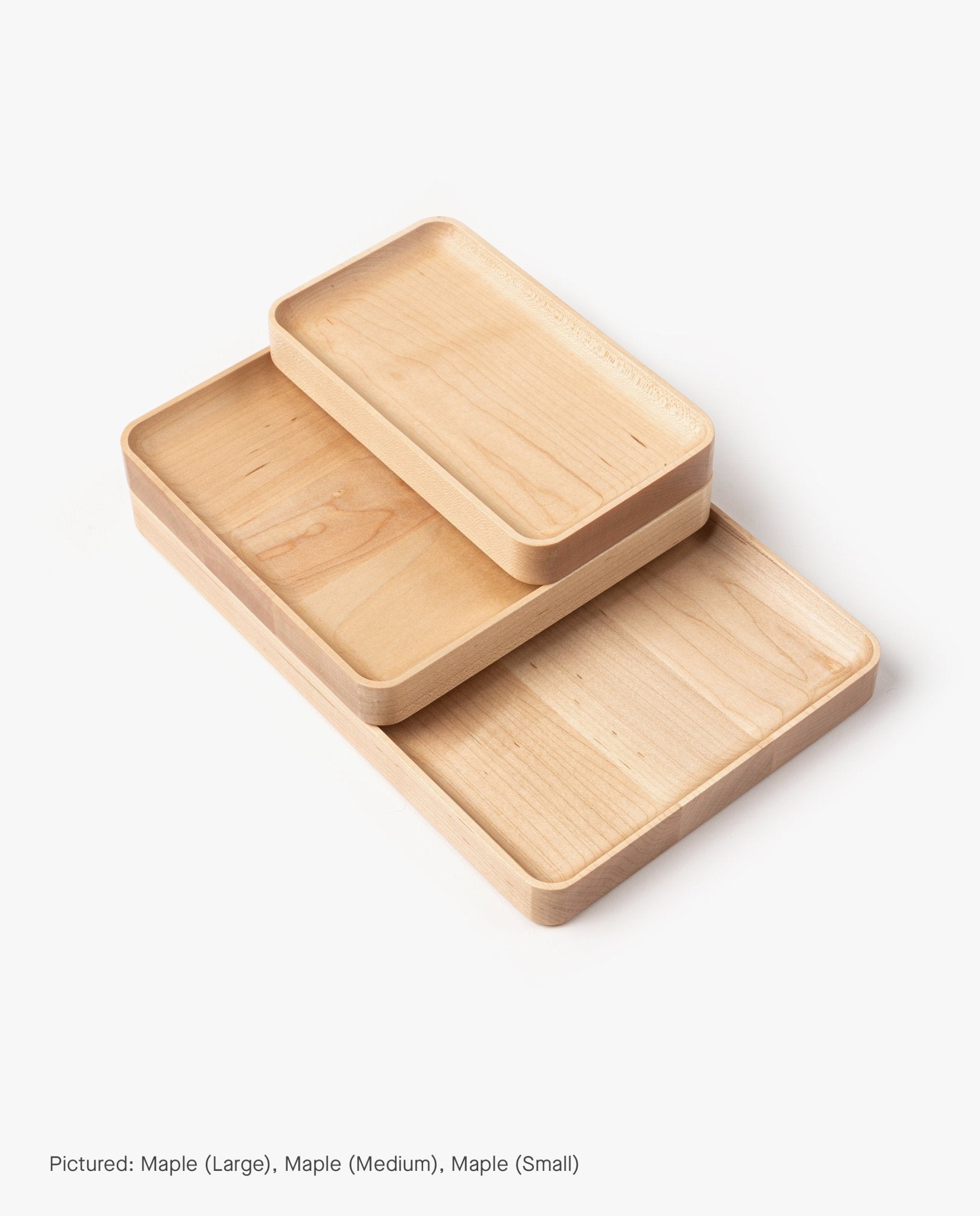 The Valet Tray Bundle (Maple - Set of 3) features three handcrafted solid maple trays in varying sizes, each with smooth edges and a light natural finish, stacked so each tray slightly overlaps the one below.