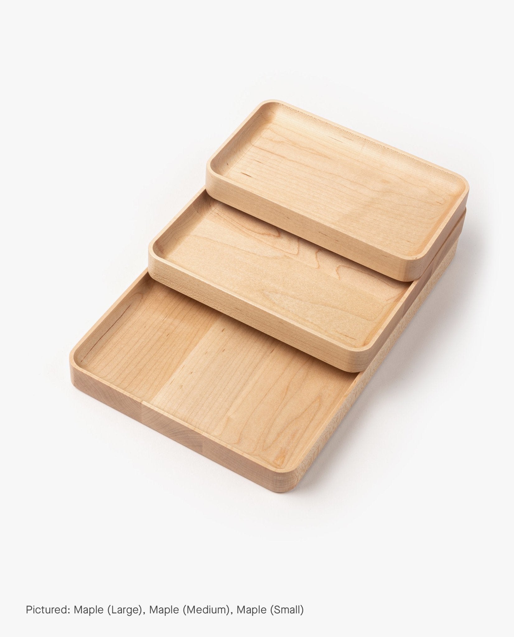 A small rectangular valet tray, meticulously handcrafted from solid maple, is displayed on a white background.
