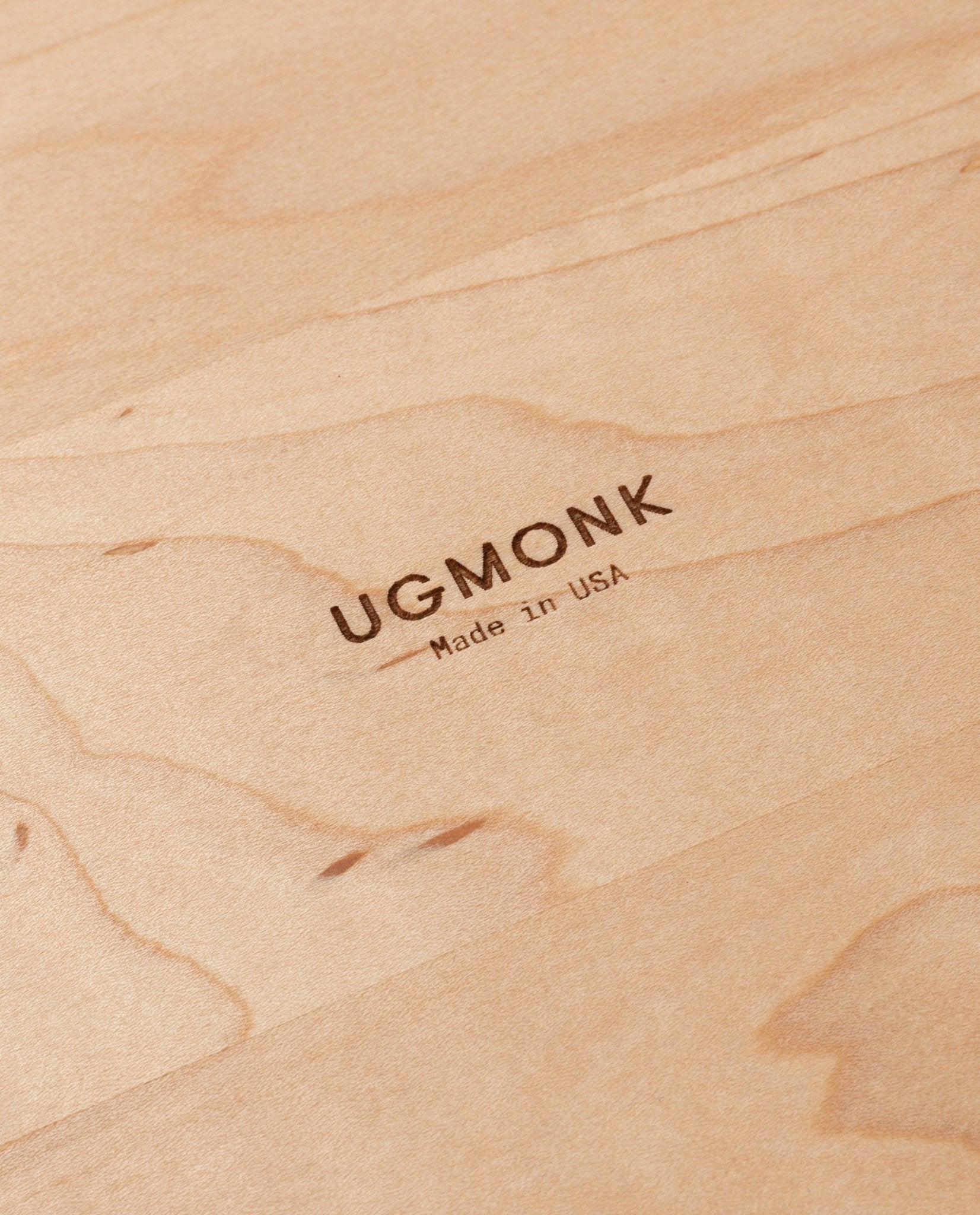 Close-up of a Valet Tray (Maple - Medium) with "UGMONK Made in USA" engraved in the center. The handcrafted maple wood grain is clearly visible.