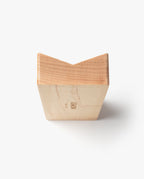 A single solid maple Pen Tray stands upright on a white background, with a V-shaped notch cut into the top edge. This Pen Tray (Maple) is expertly made in Pennsylvania.