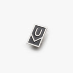 The Ugmonk Enamel Pin features a rectangular black design with a raised silver outline forming a stylized "U" above a check mark, shown against a plain white background.
