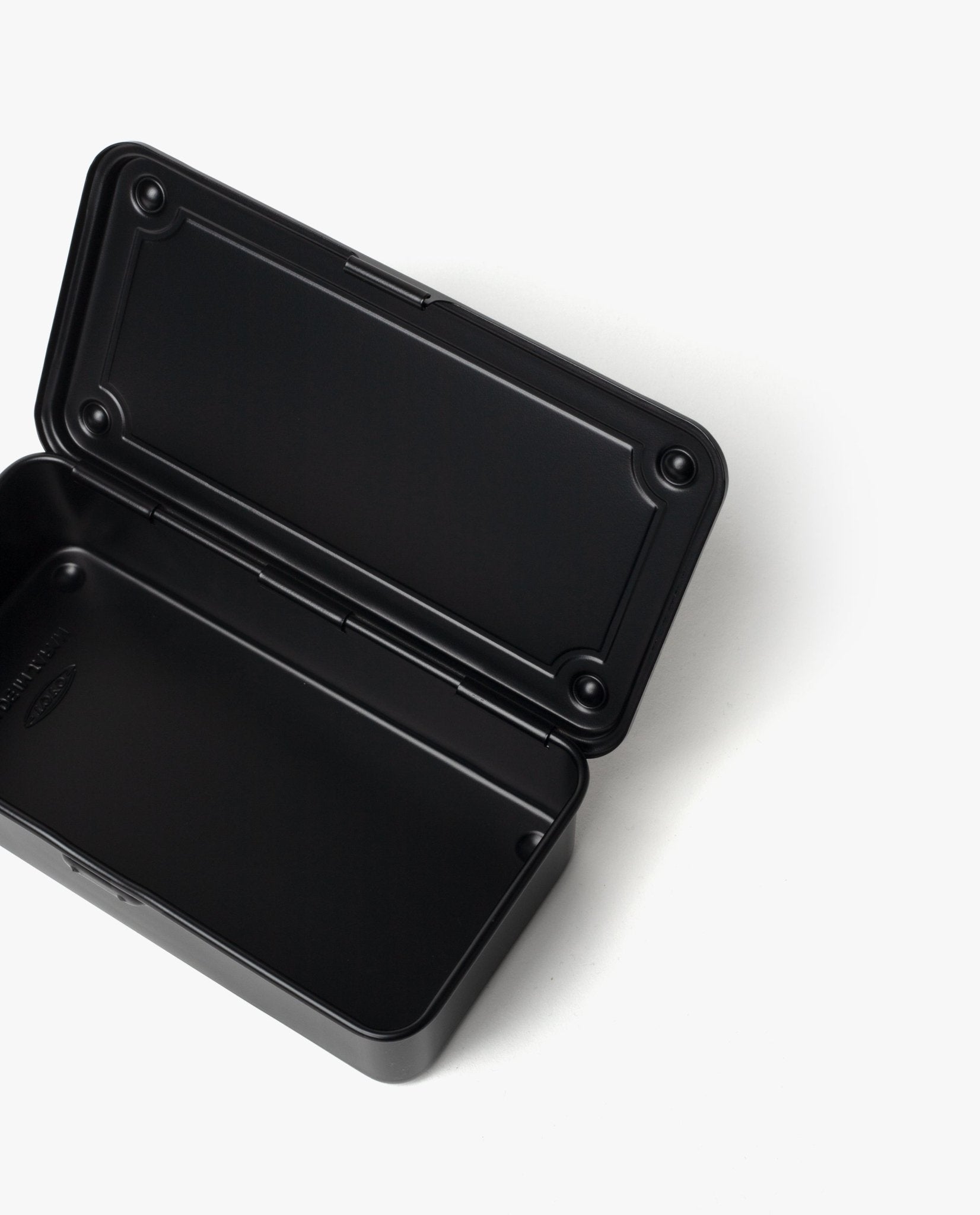 The Toyo Steel Stackable Storage Box T-190 (Black) is a black, rectangular steel toolbox with rounded corners, shown open on a white background. Made in Japan, it boasts an empty interior for versatile, durable storage and easy stacking.