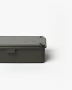 The Toyo Steel Stackable Storage Box T-190 in Military Green is a minimalist Japanese-made steel box with rounded edges, a flat screw-fastened lid, and stackable design, shown partially set against a plain white background.