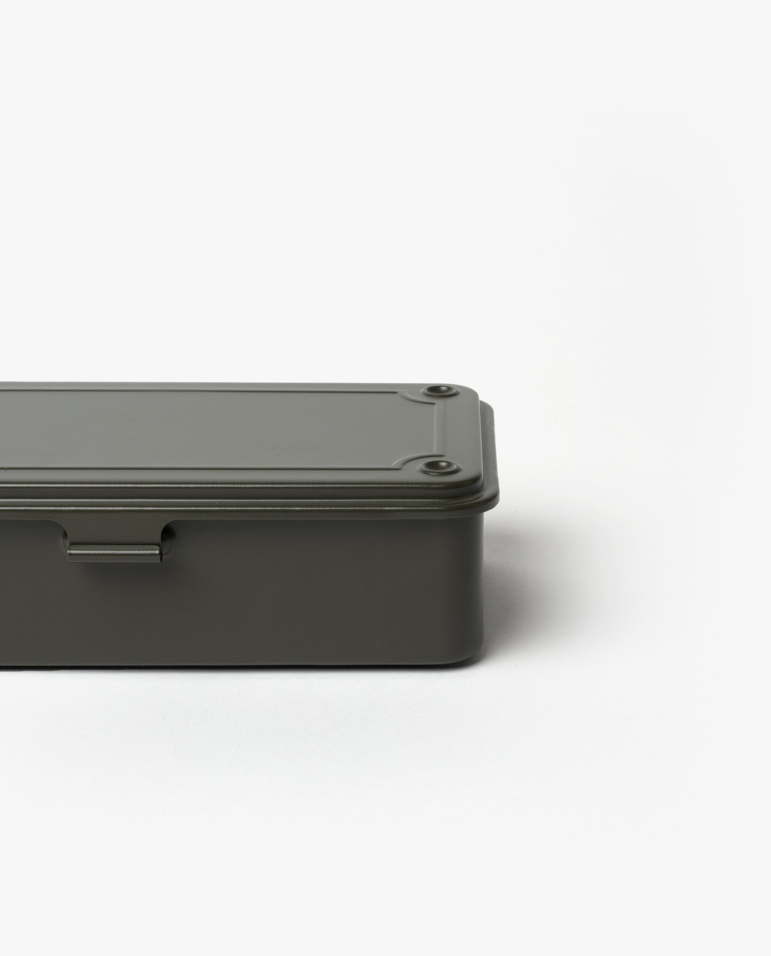 The Toyo Steel Stackable Storage Box T-190 in Military Green is a minimalist Japanese-made steel box with rounded edges, a flat screw-fastened lid, and stackable design, shown partially set against a plain white background.
