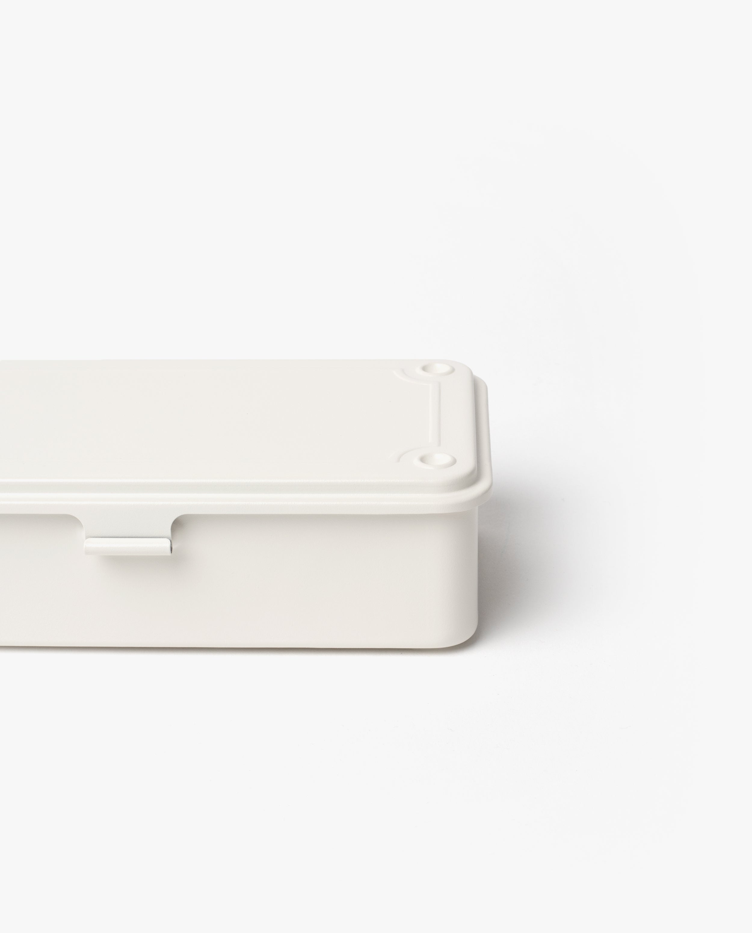 A Toyo Steel Stackable Storage Box T-190 in white, featuring a minimalist rectangular design with a lid, is shown from an angled perspective with part of the container cut off on the right side, set against a plain white background.