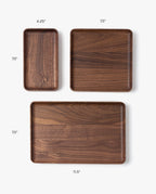 The Valet Tray (Walnut - Small), handcrafted in Pennsylvania, measures 4.25" x 7.5". Perfect for everyday carry storage, it’s displayed alongside medium (7.5" x 7.5") and large (11.5" x 7.5") trays on a white background.