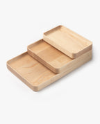 The Valet Tray Bundle (Maple - Set of 3) features handcrafted rectangular trays of different sizes with rounded corners and smooth edges, made in Pennsylvania and stacked together on a white background.