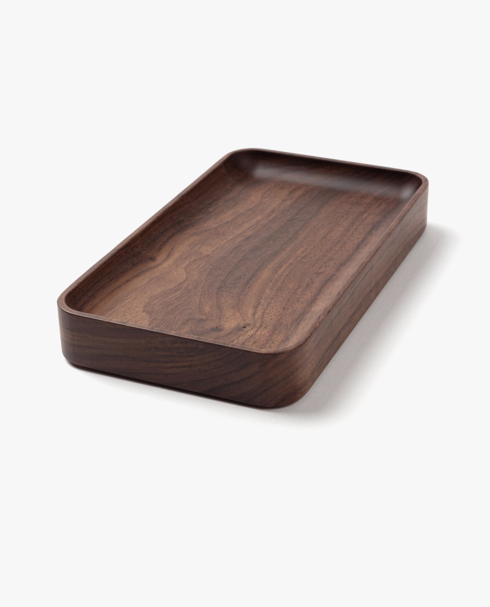 The Valet Tray (Walnut - Small) is a handcrafted, rectangular tray with rounded edges and a smooth dark walnut finish, made in Pennsylvania—ideal for storing everyday essentials. Shown on a plain white background.