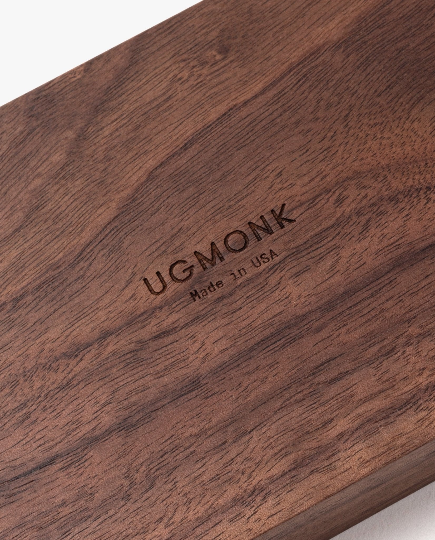 A close-up of the polished walnut surface engraved with "UGMONK Made in USA," showcasing the small Valet Tray—ideal for everyday carry storage and handcrafted in Pennsylvania.