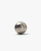 The Craighill Venn Puzzle (Stainless Steel) is a smooth, metallic sphere with a subtle curved seam, elegantly resting on a plain white background.